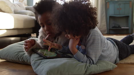 Two-Children-Playing-With-Digital-Tablet-At-Home-Shot-On-R3D