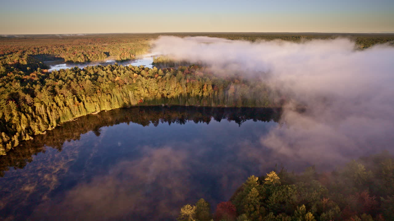 Overhead drone shot showing mist elevating off the water at sunrise
