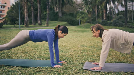 active ladies sport workout summer park. athlete girls clapping hands together