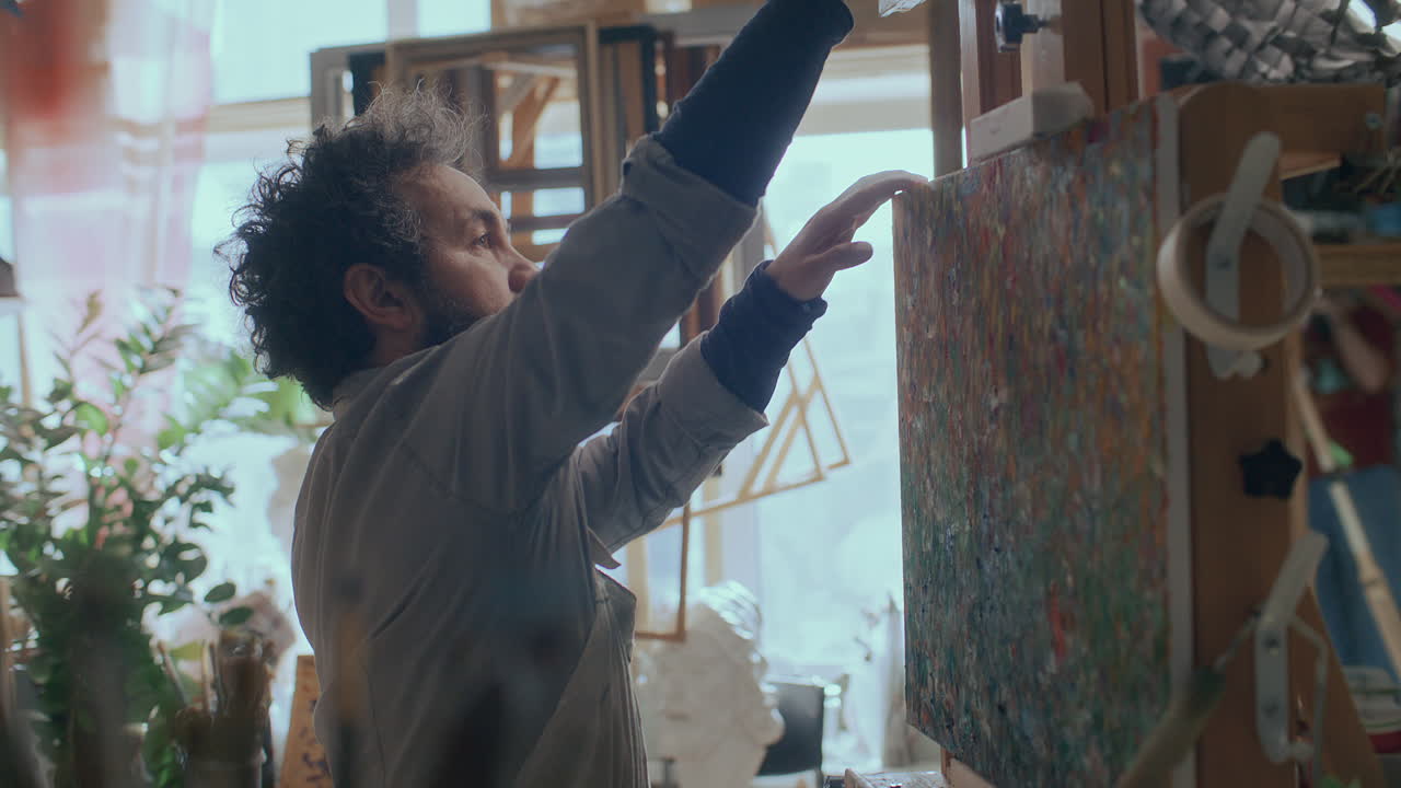 Painter Walking in Creative Studio and Setting Up Canvas on Easel