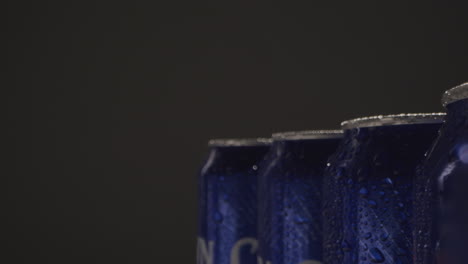 close up or macro shot of condensation droplets on takeaway cans of cold beer or soft drinks against black background 2