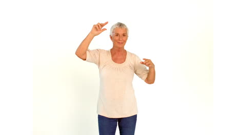 Senior-woman-dancing-against-white-background