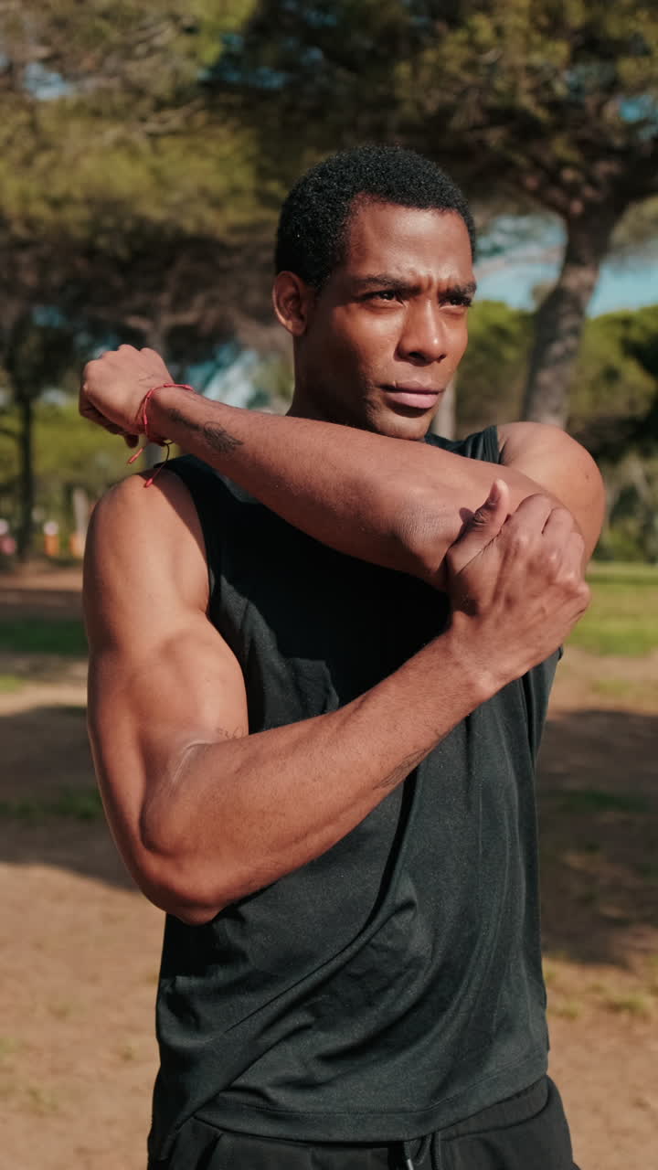 Young Man Stretching in Park Before Workout