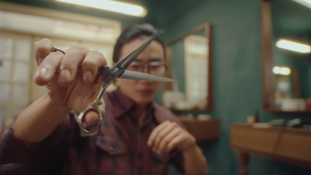 Barber Holding Hairdressing Scissors In Front Of The Camera