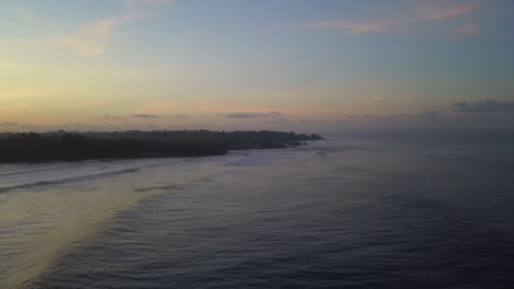 pre sunrise dawn aerial as ocean waves roll