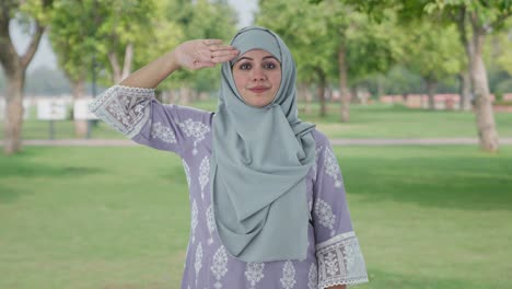 proud muslim woman saluting on independence day in park