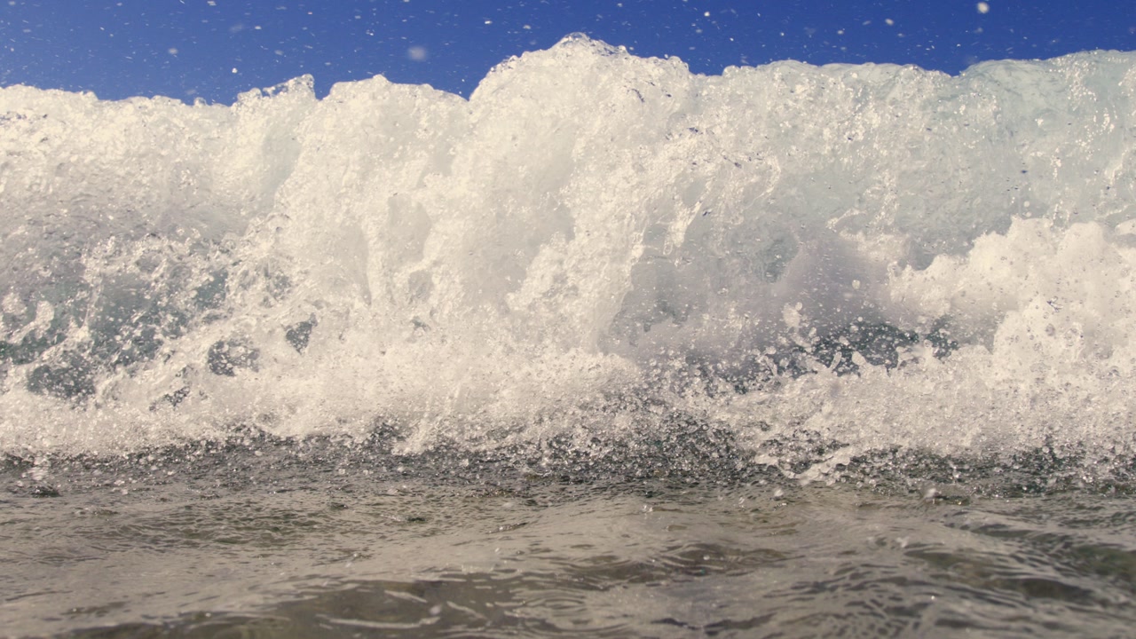 Slow motion wave crashing on Karpathos beach, serene and majestic