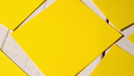 animation of multiple yellow cards lying on wooden table