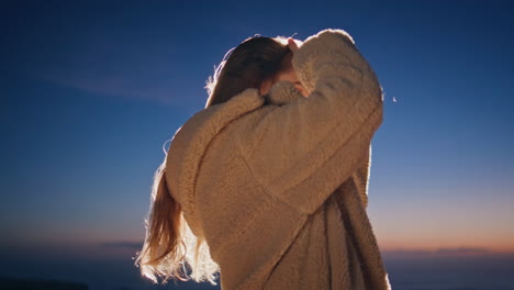 fashion girl modeling sunrise beach in fur coat at morning closeup. woman dance