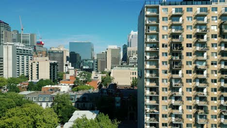 4K-Cinematic-urban-drone-footage-of-an-aerial-view-of-buildings-and-skyscrapers-in-the-middle-of-downtown-Montreal,-Quebec-on-a-sunny-day