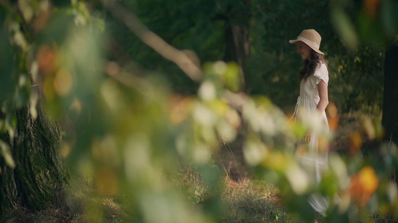 Happy girl running with flowers at sunset