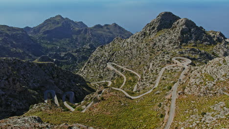 serpentine asphalt roads of nus de sa corbata at coll dels reis rocky mountains in mallorca, spain