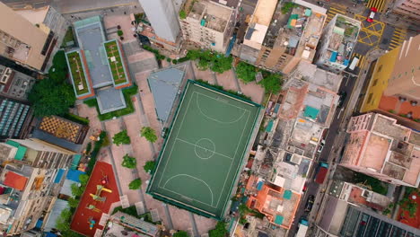 football field - aerial view of outdoor football pitch with cityscape and traffic in hong kong