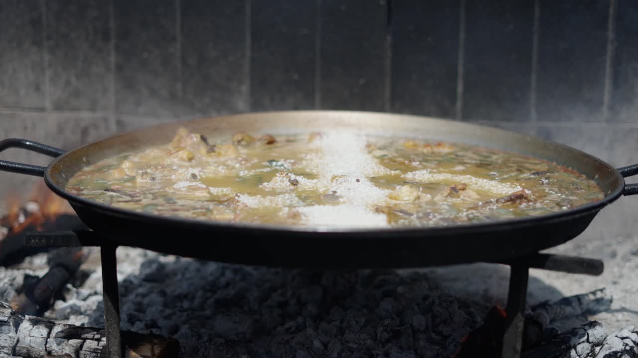Traditional Paella Cooking Over Open Fire