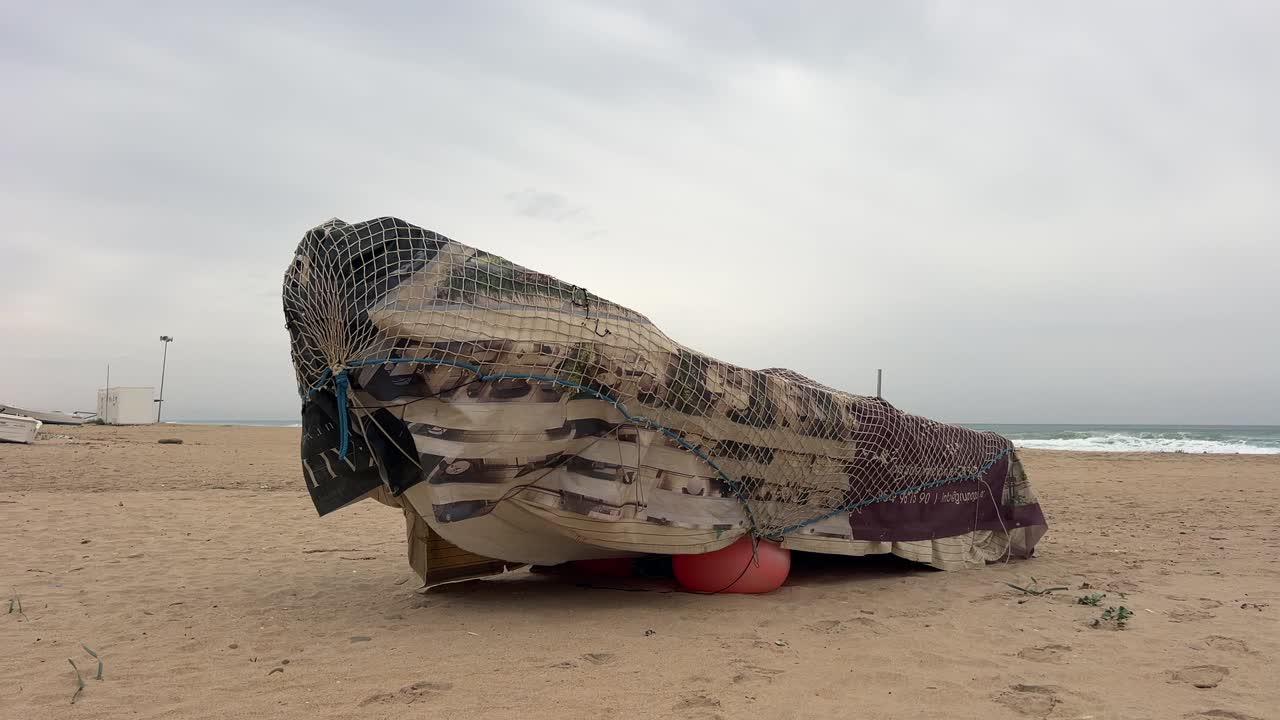 Lonely Beach with Covered Boat and Dog Playing on a Cloudy Day