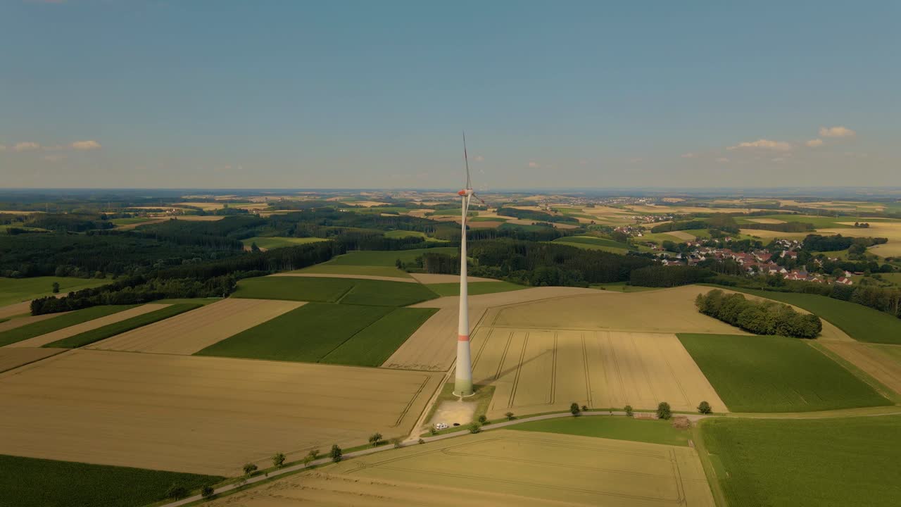Drone flight towards windmill at corn field