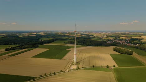 drone flight towards windmill at corn field