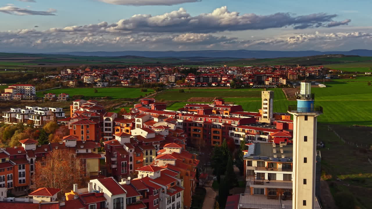 Captivating sunset over a charming village with colorful buildings in a serene landscape, showcasing nature's beauty and local architecture