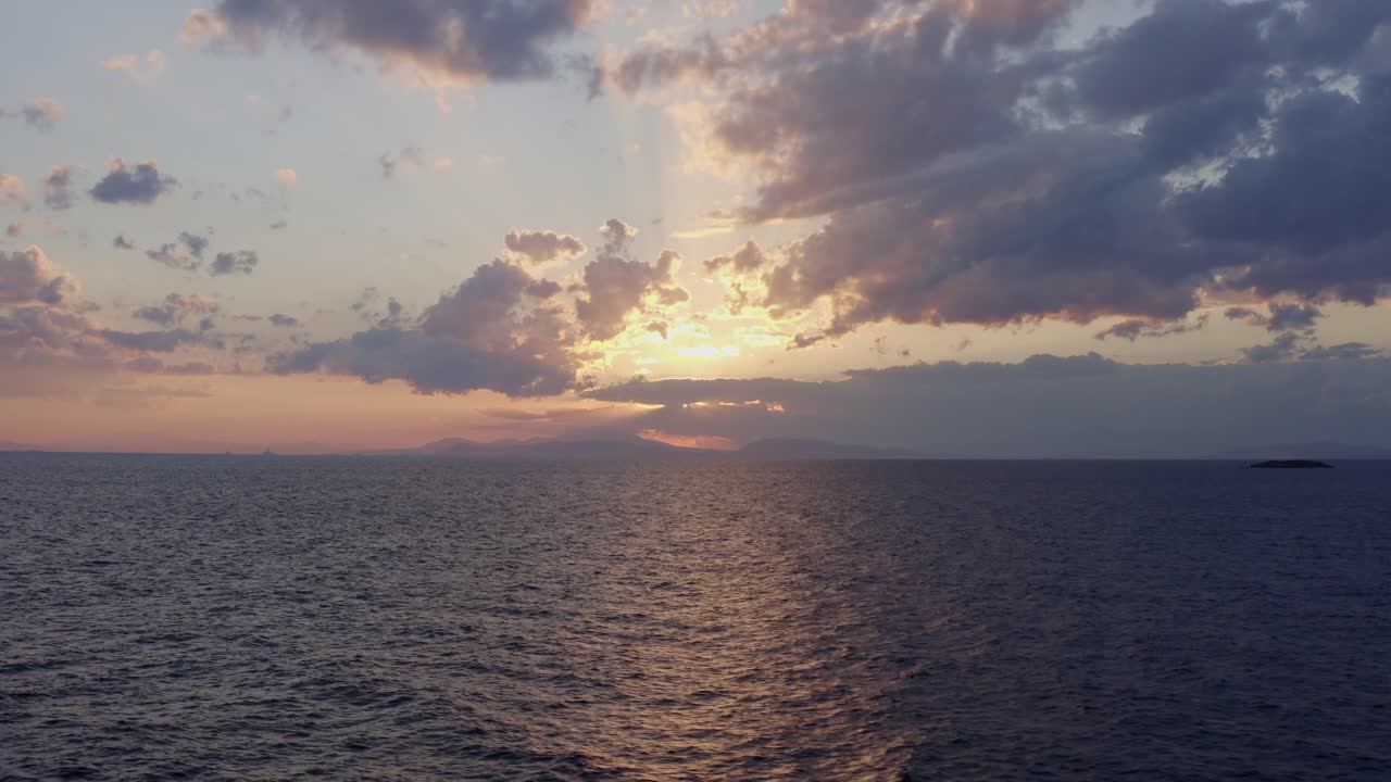 Aerial - Flying above the sea at sunset