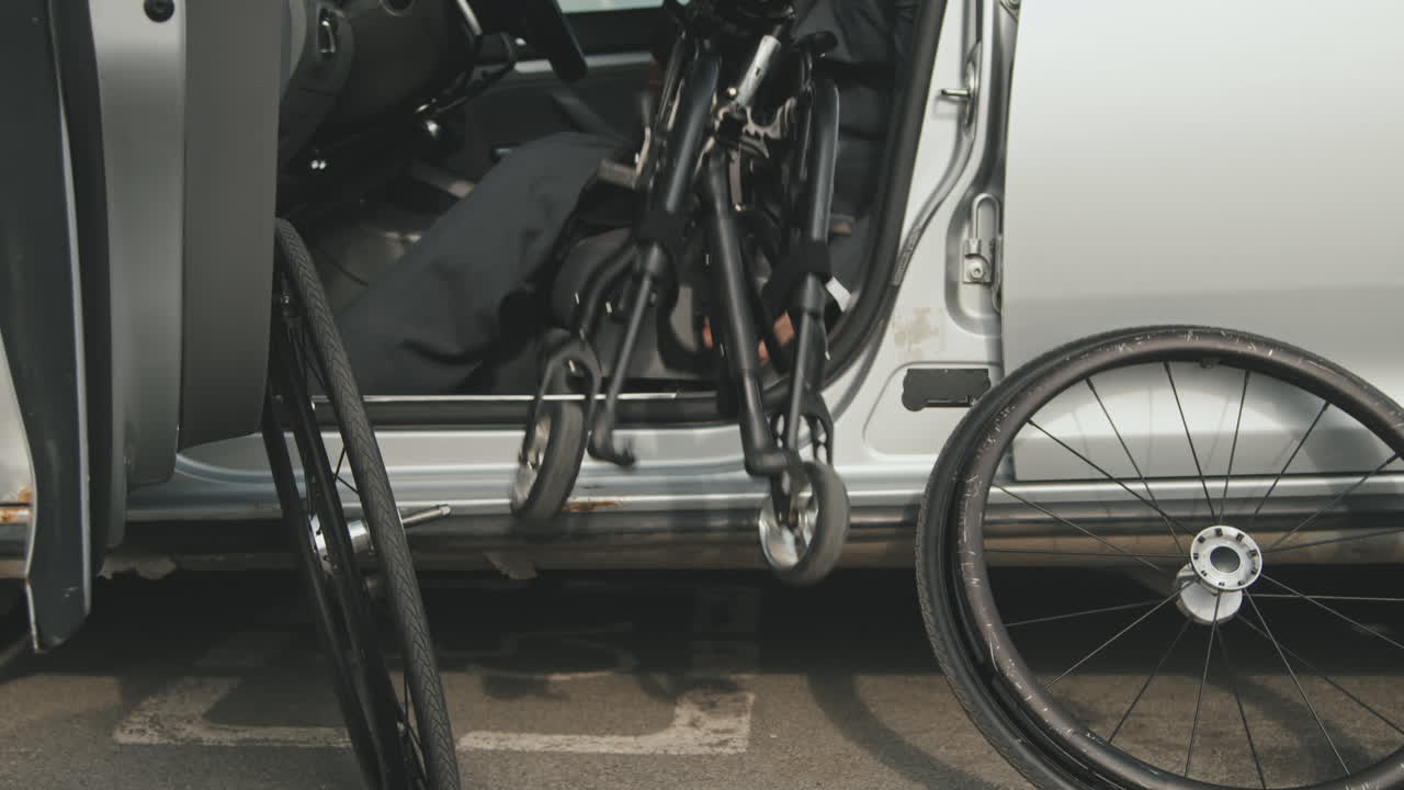 Businessman Putting Wheelchair into Car