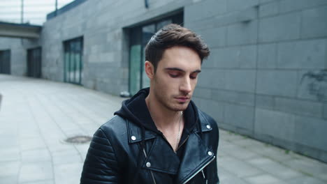 Portrait-of-hipster-man-walking-street-in-slow-motion.-Focused-man-walking-city