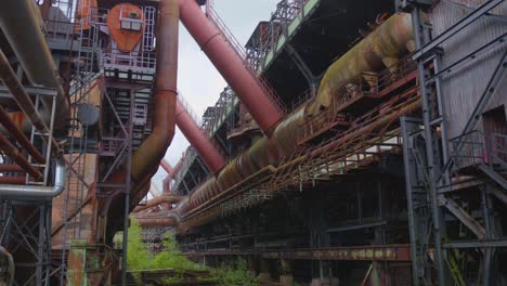 industrial ironworks structure with pipes in deserted factory complex