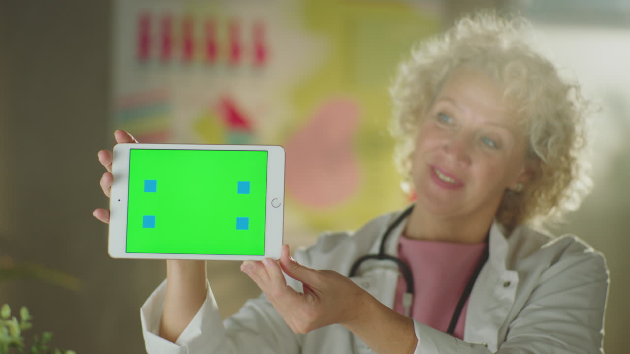 Doctor presenting on tablet with green screen