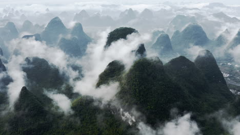 amazing karst mountain landscape in cloud, guangxi china, 4k aerial pull-back