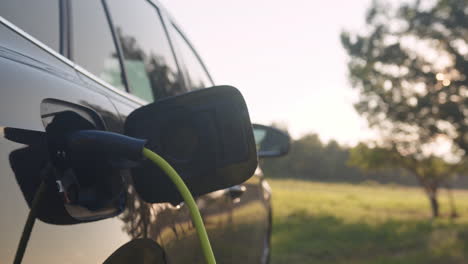 Coche-Eléctrico-Con-El-Cable-De-Alimentación-Enchufado,-Primer-Plano