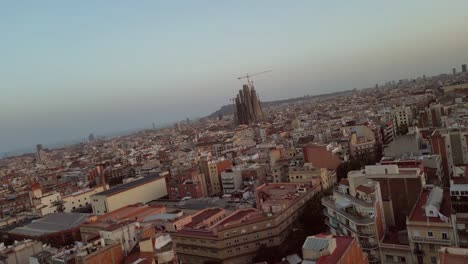 Aerial-drone,-fast-moving-shots-of-the-Barcelona-City,-Catalonia-housing-community,-and-Sagrada-Familia