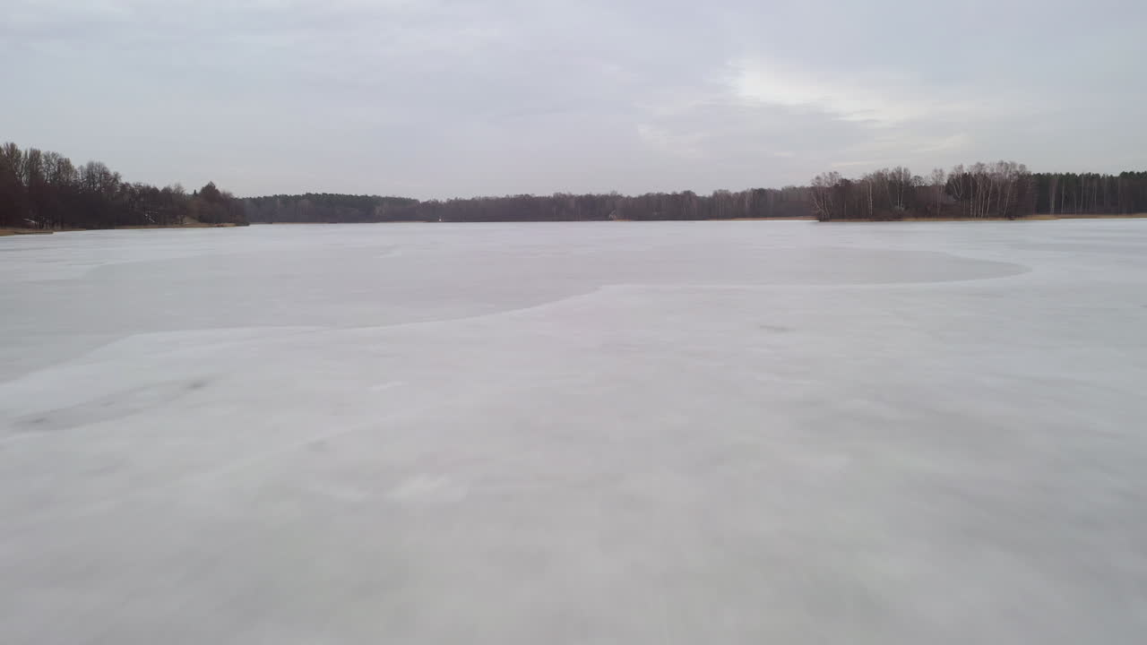AERIAL: Descending From Height to the Frozen Lake Surface on a Cloudy Day