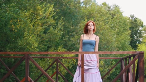 woman standing on a wooden bridge in a park