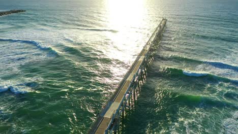 slow motion beach view of jetty at sunrise, peaceful calm