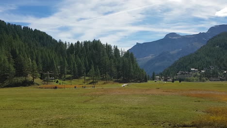 People-Walking-Between-The-Mountains-Of-The-Beautiful-Italian-Alps