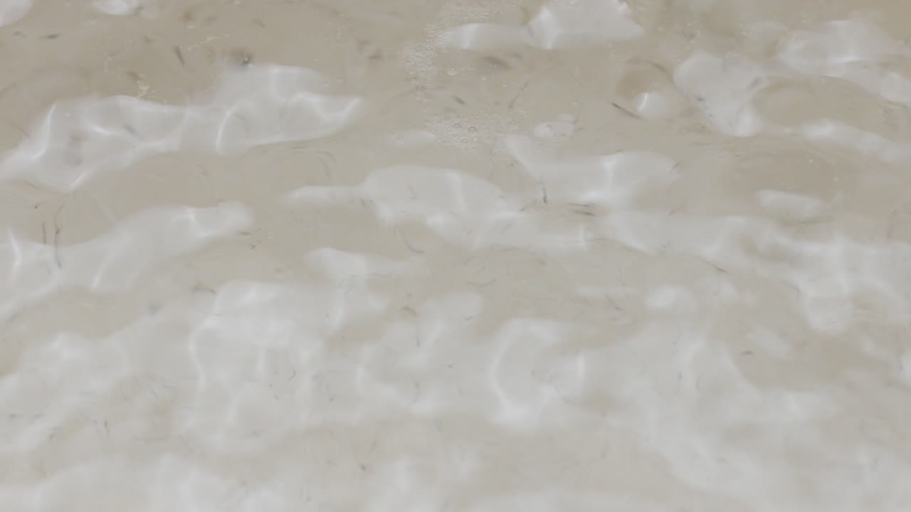 Closeup Of Boiling Water With Bubbles And Ripples. macro shot