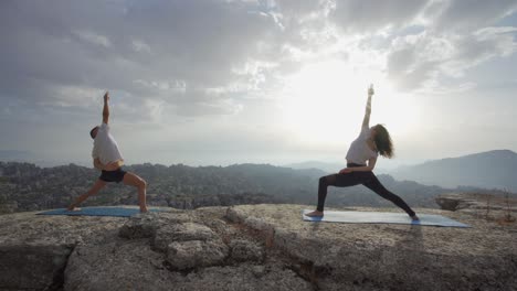 Couple-practicing-yoga-in-mountains