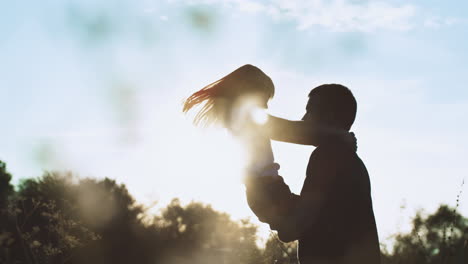 father and daughter silhouette at sunset