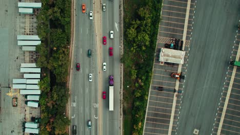 top down aerial following a purple semi tractor with a white trailer