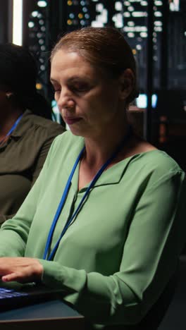 vertical video female supervisor and her staff members reviewing efficiency metrics