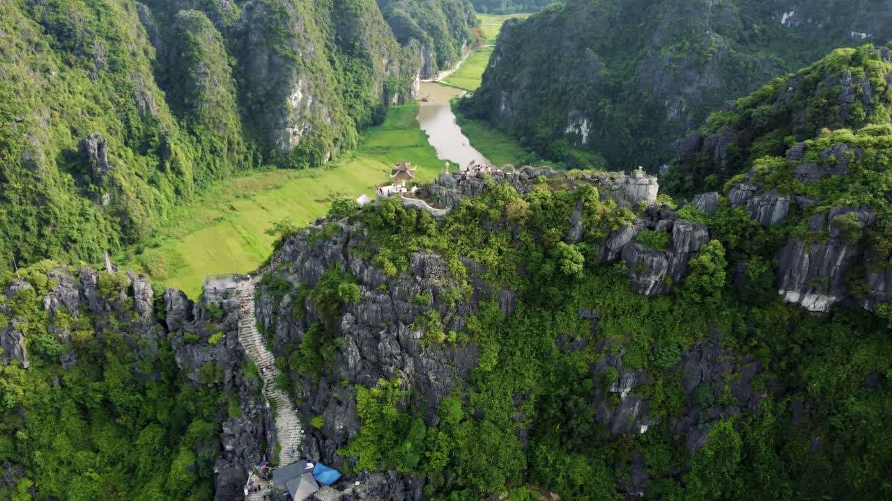 volando a lo largo del borde de la cima de la montaña hang moo y capturando un templo del dragón en ninh binh, vietnam