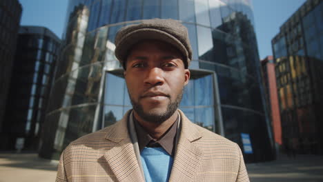 portrait of young african american businessman with coffee outdoors