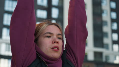 training partner grips pull up bars lifting legs high in dynamic urban park workout, modern building backdrop, autumn light, and children rollerblading nearby adds lively contrast, vibrant energy