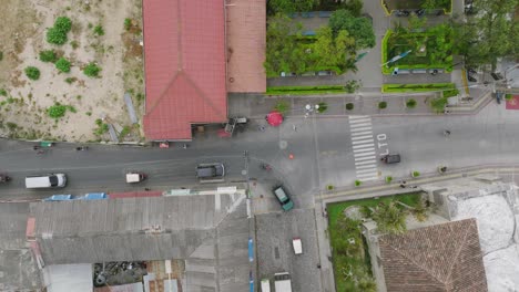 Imágenes-Aéreas-De-Arriba-Hacia-Abajo-De-Una-Intersección-En-Panajachel,-Guatemala-Con-Autos-Yendo-Y-Frenando-Y-Gente-Caminando