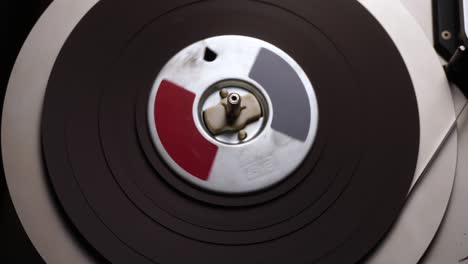 Spinning-Reel-to-Reel-Audio-Tape-in-Professional-Magnetophone,-Close-Up