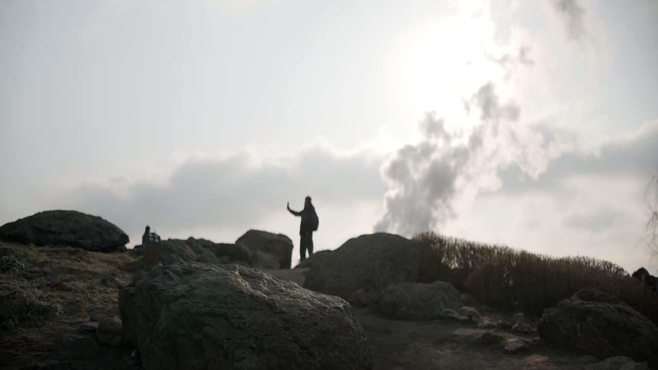Person taking photo at a geothermal area