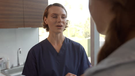 doctor meets with teenage patient in examination room