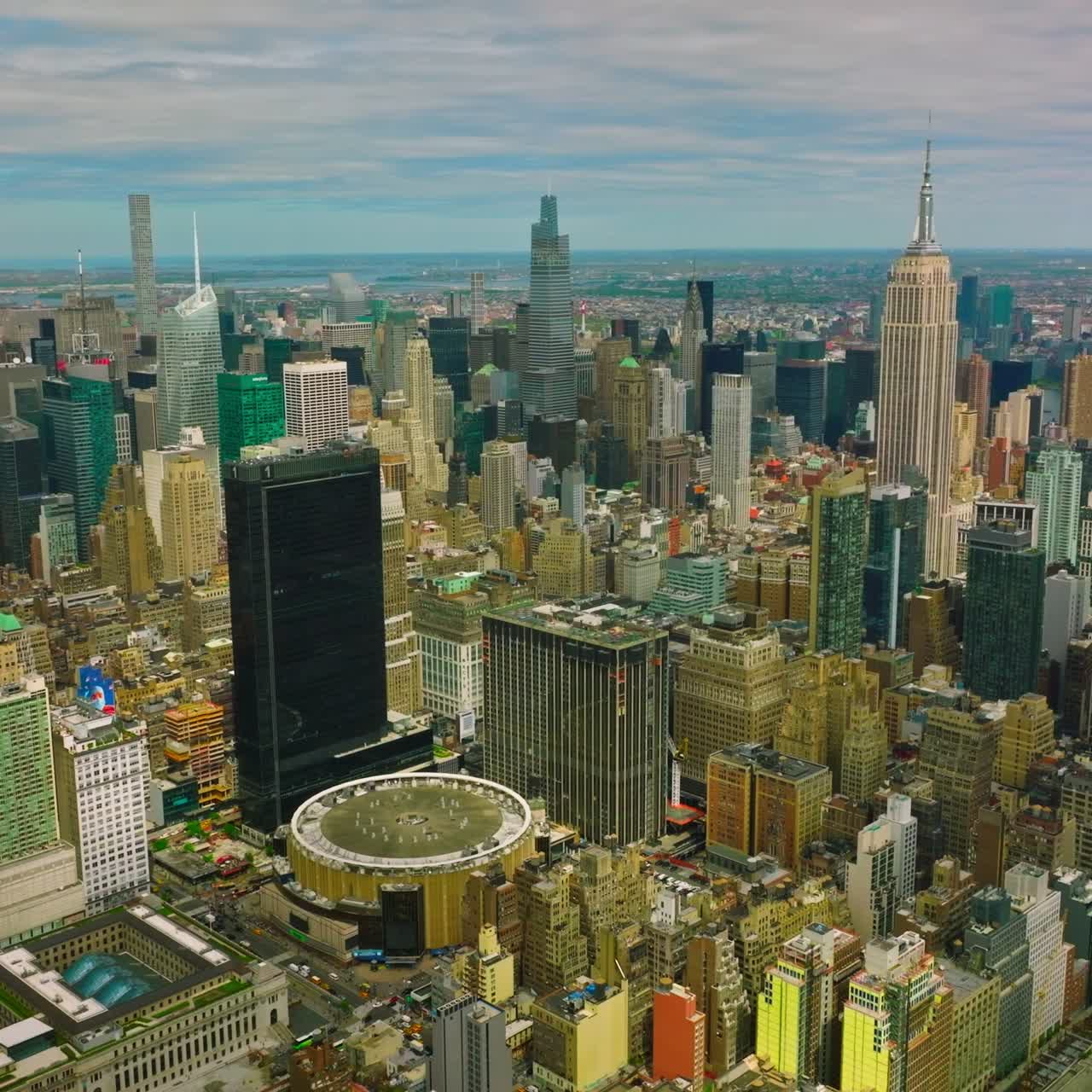 Densely built New York city panorama at daytime. Outstanding metropolis at the backdrop of cloudy sky
