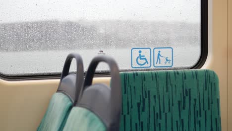 rainy train interior with accessibility symbols