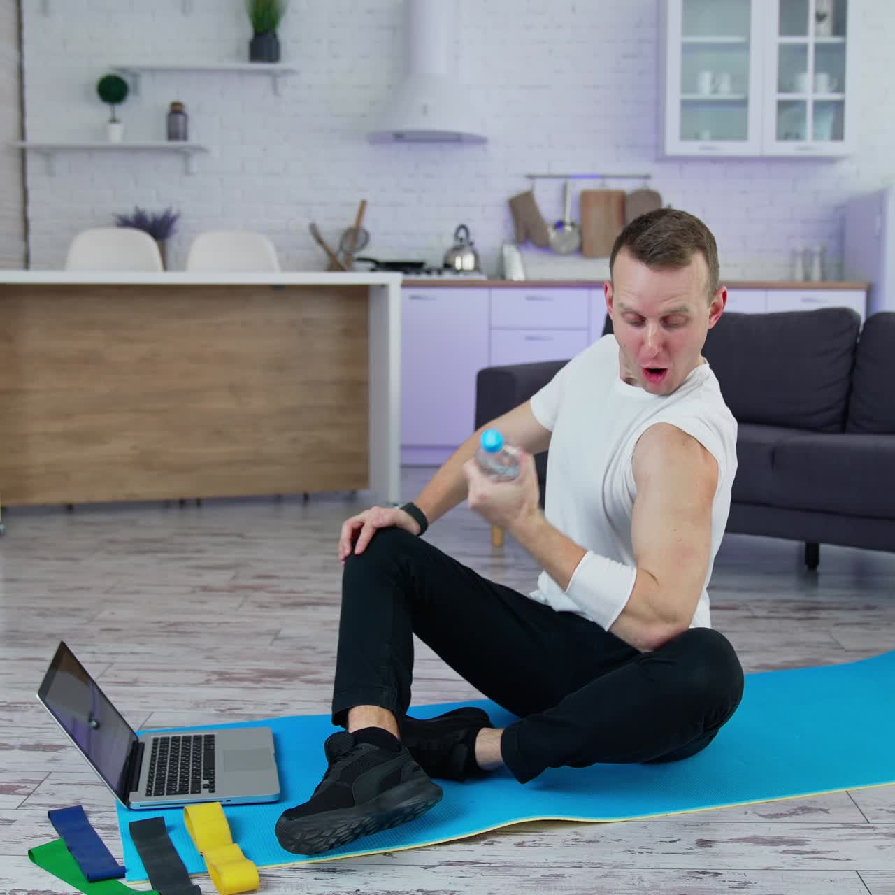 Sport exercises at home. A man uses household items for sport exercises