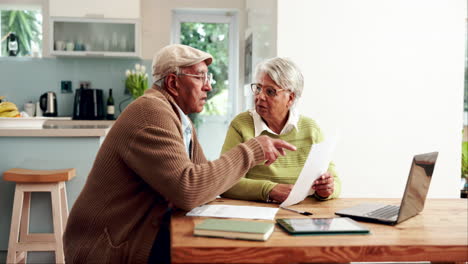 elderly couple reviewing documents and financial planning at home